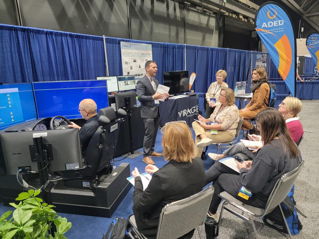 Virage Simulation's booth at the ADED 2024 conference in Kansas City, MO. Presenting the VS500M clinical car driving simulator. Keegan Humphrey presenting the clinical assessment program.